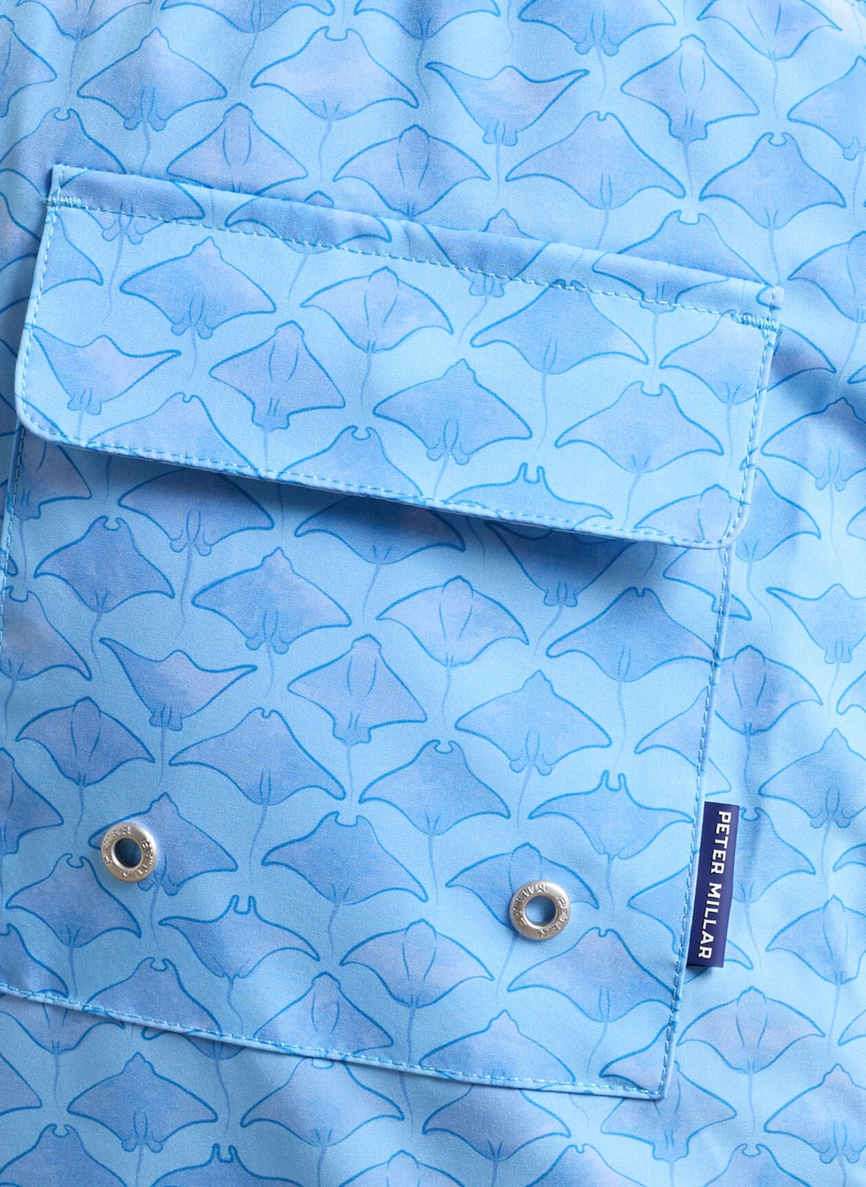 Coronado Swim Trunk close-up of blue animal print pocket with Peter Millar tag and grommets