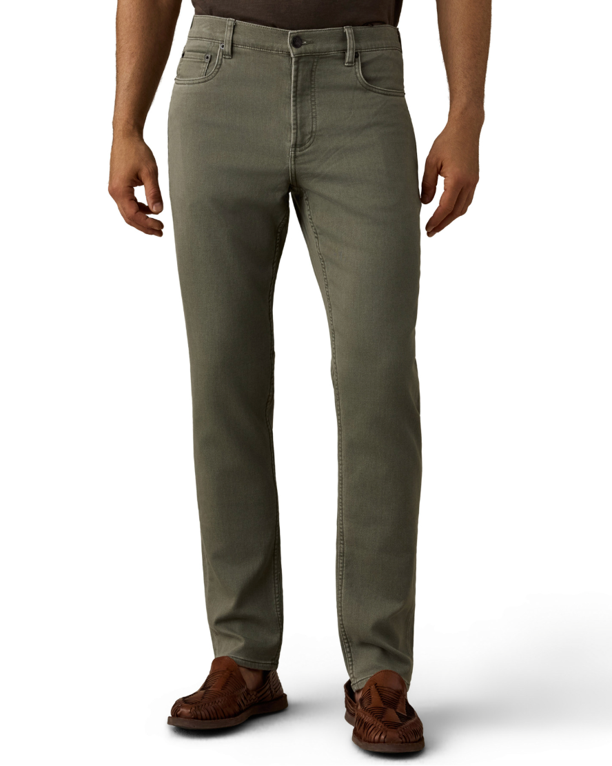 Man wearing olive green straight-leg pants and brown leather moccasins against a white background