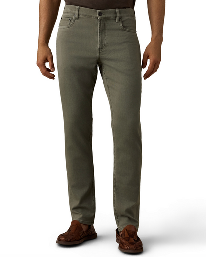 Man wearing olive green straight-leg pants and brown leather moccasins against a white background