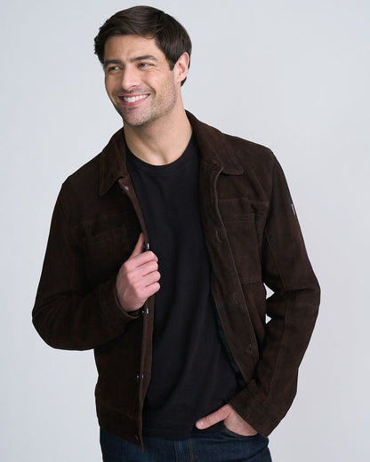 Smiling man wearing a brown jacket over a black shirt